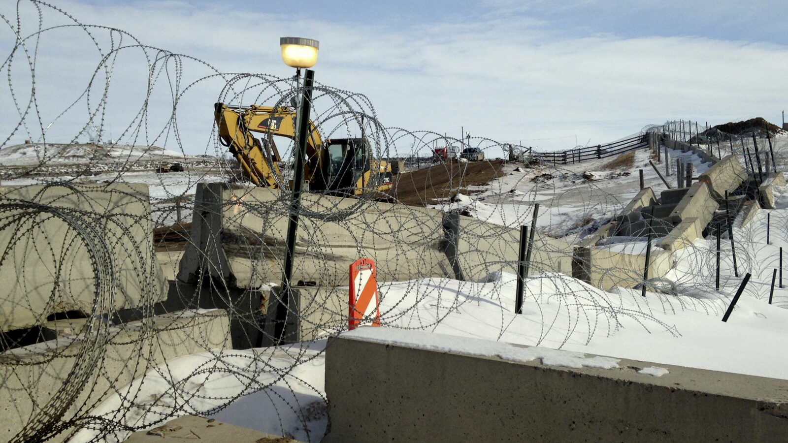 Razor wire and concrete barriers protect access to the Dakota Access pipeline drilling site Thursday, Feb. 9, 2017 near Cannon Ball, North Dakota. (AP/James MacPherson)