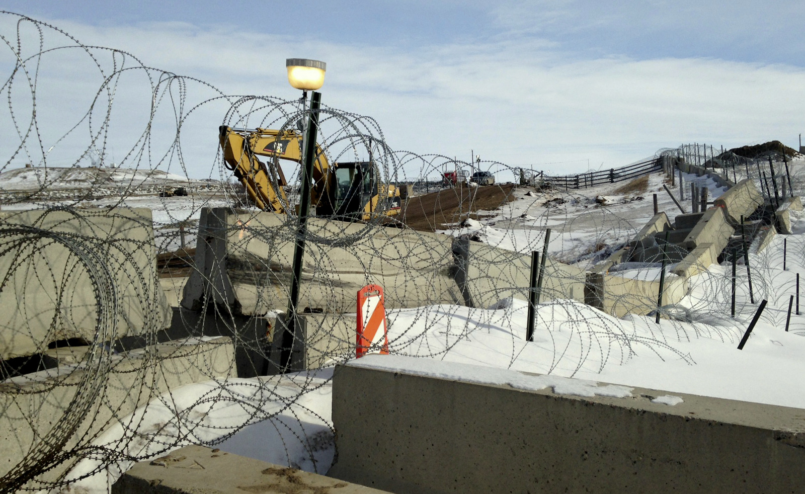 Razor wire and concrete barriers protect access to the Dakota Access pipeline drilling site Thursday, Feb. 9, 2017 near Cannon Ball, North Dakota. (AP/James MacPherson)