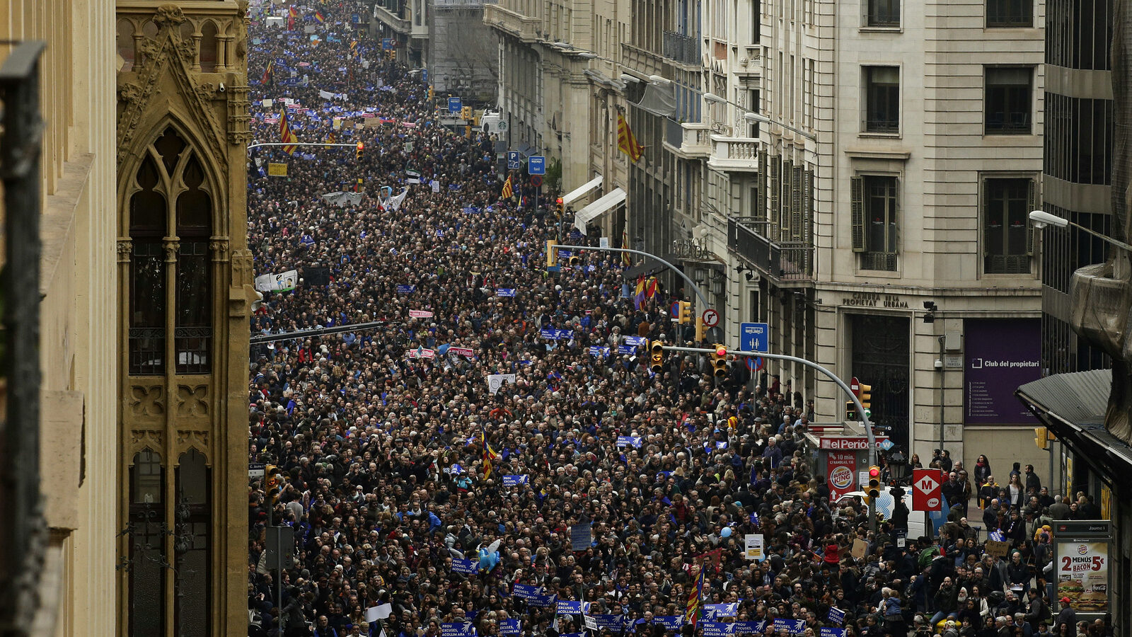 Thousands of people march to demand Spain's government to increase its efforts to take in refugees who have fled the war in Syria and other violent conflicts in Barcelona, Spain, Saturday, Feb. 18, 2017. Spain has taken in just 1,100 refugees of the over 17,000 it has pledged to accept. Banner reads in Catalan: "Enough Excuses! Take Them In Now!". (AP/Manu Fernandez)