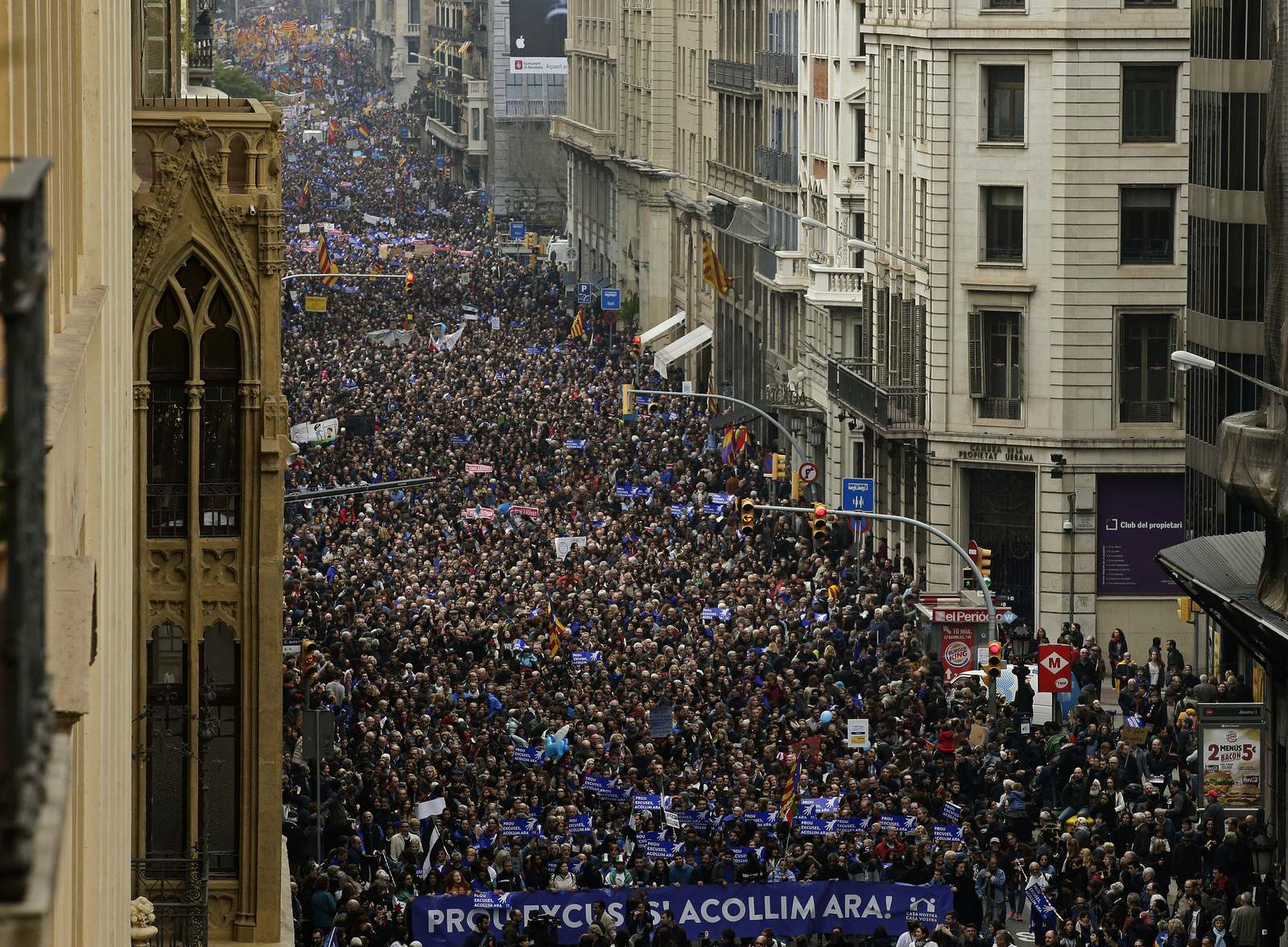 Thousands of people march to demand Spain's government to increase its efforts to take in refugees who have fled the war in Syria and other violent conflicts in Barcelona, Spain, Saturday, Feb. 18, 2017. Spain has taken in just 1,100 refugees of the over 17,000 it has pledged to accept. Banner reads in Catalan: "Enough Excuses! Take Them In Now!". (AP/Manu Fernandez)