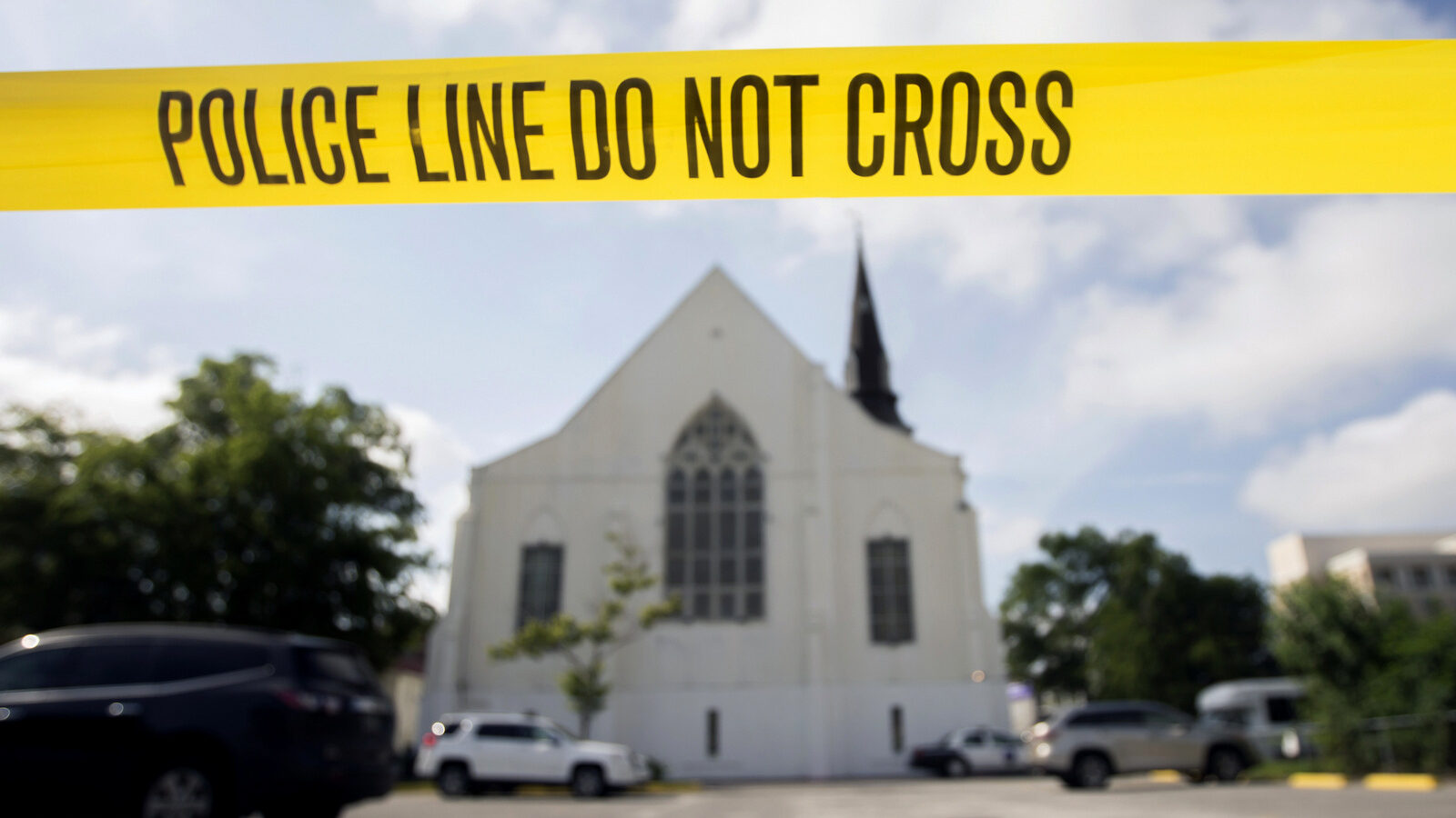 Police tape surrounds the parking lot behind the AME Emanuel Church as FBI forensic experts work the crime scene where nine people where shot by Dylann Storm Roof, 21, in Charleston, S.C. Since the Oklahoma City bombing in 1995, the Southern Poverty Law Center has tracked domestic terrorist plots and attacks in the United States. It lists more than 100, including the slaying of nine black churchgoers during a 2015 prayer meeting in Charleston, S.C. (AP/Stephen B. Morton)