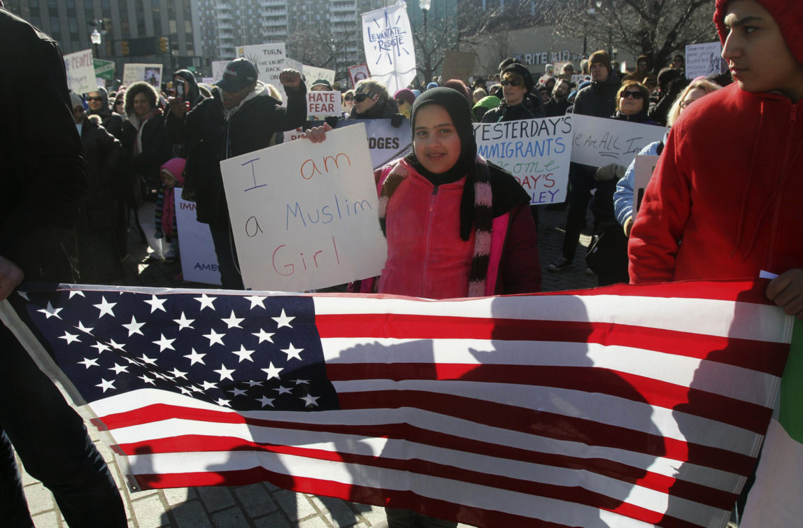 Noor Almeky, 10, holds up a sign during a rally on Public Square in Wilkes Barre, Pa., Saturday, Feb. 4, 2017, protesting President Donald Trump's executive order. (Dave Scherbenco/The Citizens' Voice via AP)