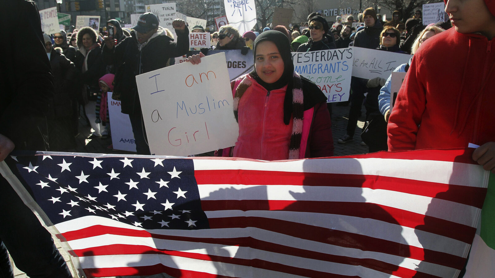 Noor Almeky, 10, holds up a sign during a rally on Public Square in Wilkes Barre, Pa., Saturday, Feb. 4, 2017, protesting President Donald Trump's executive order. (Dave Scherbenco/The Citizens' Voice via AP)