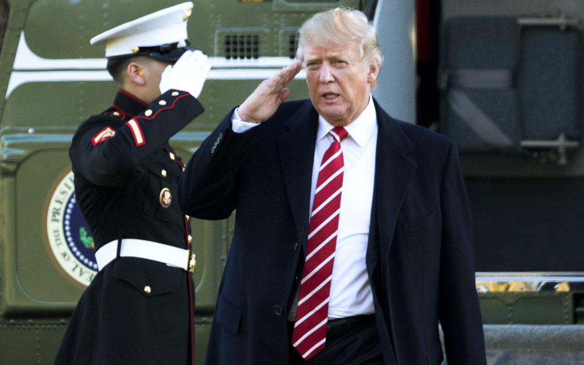 President Donald Trump salutes a Marines honor guard as he disembarks from Marine One upon arrival at the White House in Washington, Monday, Feb. 6, 2017 from a trip to Florida. (AP/Manuel Balce Ceneta)