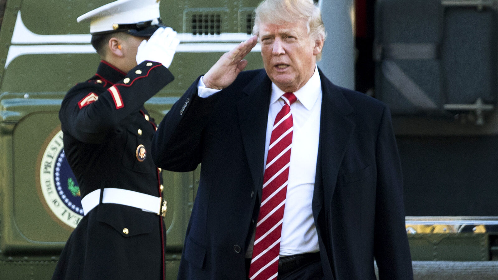 President Donald Trump salutes a Marines honor guard as he disembarks from Marine One upon arrival at the White House in Washington, Monday, Feb. 6, 2017 from a trip to Florida. (AP/Manuel Balce Ceneta)