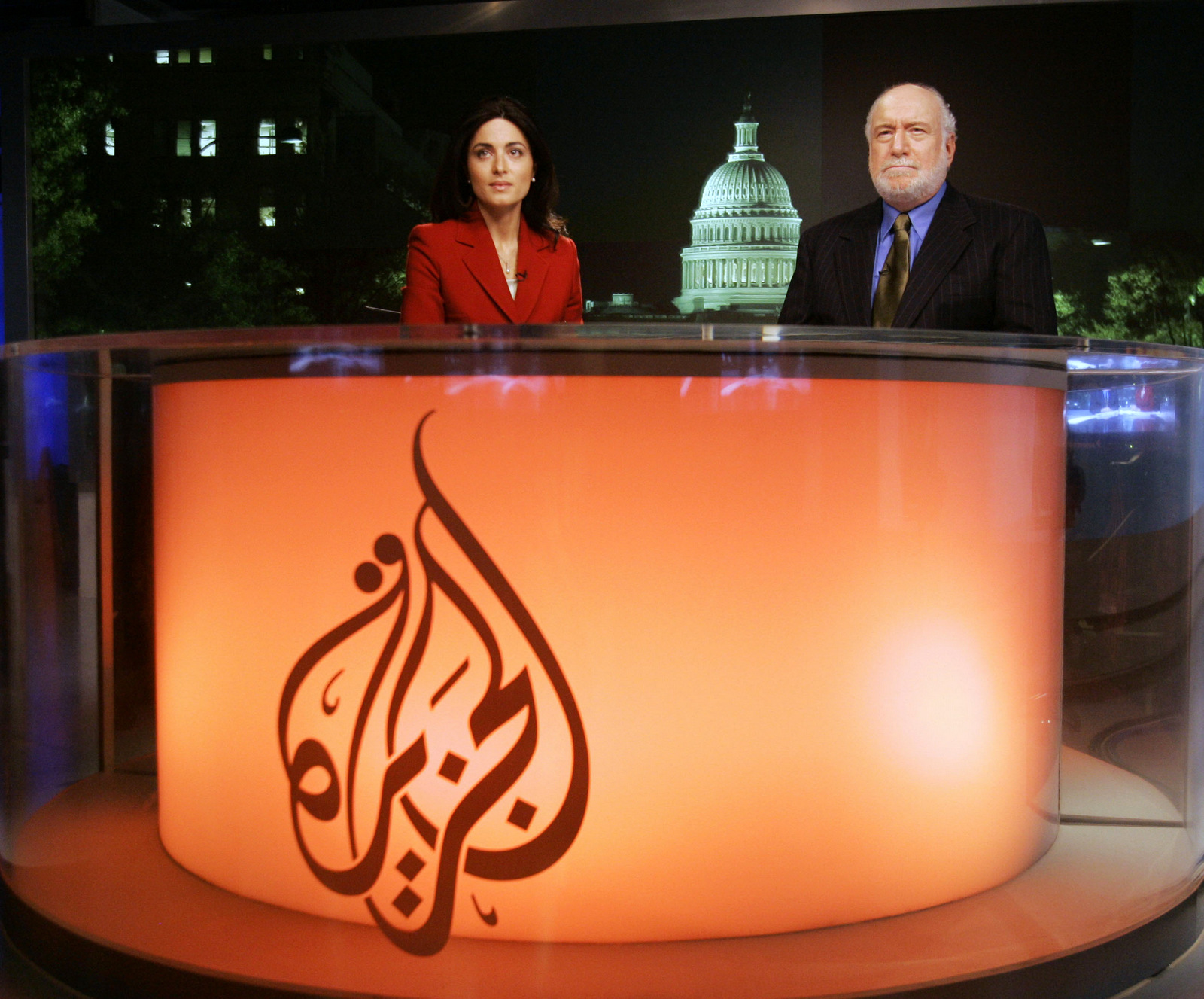 Al-Jazeera's English-language channel anchors Ghida Fakhry, left, and Dave Marash prepare for the evening news at their bureau in Washington, Friday, Nov. 17, 2006. (AP/ Haraz N. Ghanbari)