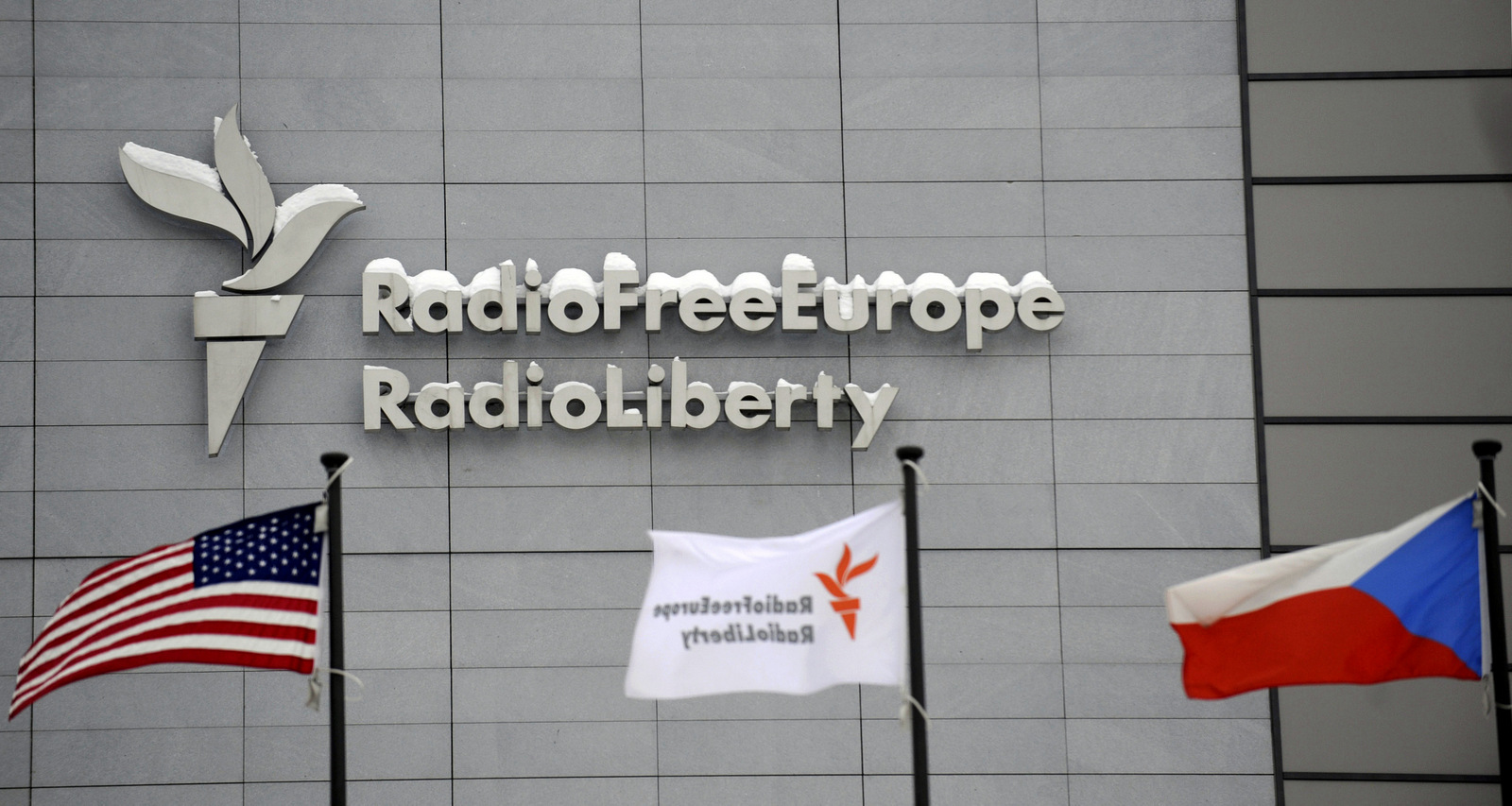 The headquarters of Radio Free Europe/Radio Liberty (RFE/RL) seen with the United States, RFE/RL and the Czech Republic flags in the foreground, in Prague Friday, Jan. 15, 2010. (AP/CTK, Michal Kamaryt)