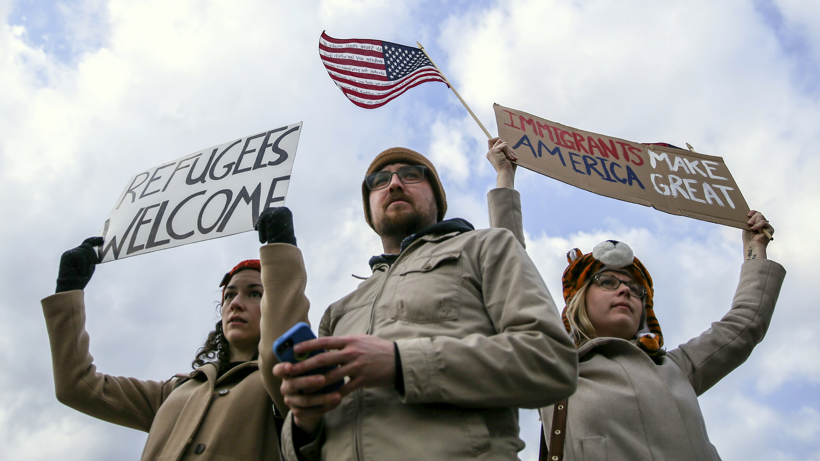 Demonstrators hold signs at Hartsfield-Jackson International Airport during a demonstration to denounce President Donald Trump's executive order that bars citizens of seven predominantly Muslim-majority countries from entering the U.S., Sunday, Jan. 29, 2017, in Atlanta. (AP/Branden Camp)