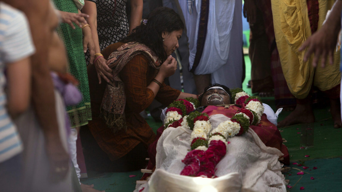 Sunaina Dumala grieves near the body of her husband Srinivas Kuchibhotla, a 32-year-old engineer who was killed in a racially motivated shooting in a crowded Kansas bar, at their residence in Hyderabad, India, Tuesday, Feb.28, 2017. According to witnesses, the gunman yelled "get out of my country" at Kuchibhotla and Alok Madasani before he opened fire at Austin's Bar and Grill in Olathe, Kansas, a suburb of Kansas City, on Wednesday evening. Both men had come to the U.S. from India to study and worked as engineers at GPS-maker Garmin. (AP/Mahesh Kumar A.)