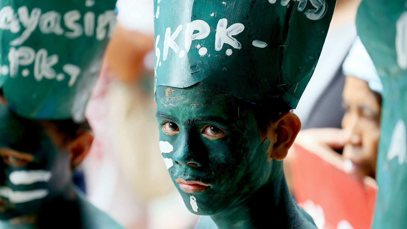 A face-painted protester joins indigenous peoples and environmentalists in a picket at a mining company in Makati city, east of Manila, Philippines, to demand its closure, Thursday, March 2, 2017. Secretary Gina Lopez of the Department of Environment and Natural Resources (DENR), whom the protesters have rally their support for her confirmation by the senate, has ordered the closure of 23 mining operations, suspended five others following a months-long audit and also canceled 75 mining contracts. (AP/Bullit Marquez)