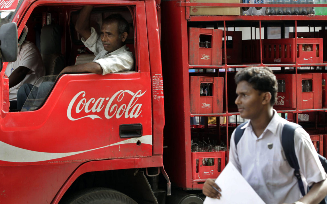 A man walks past a truck that distributes Coca Cola in Mumbai, India. (AP/Rajanish Kakade)