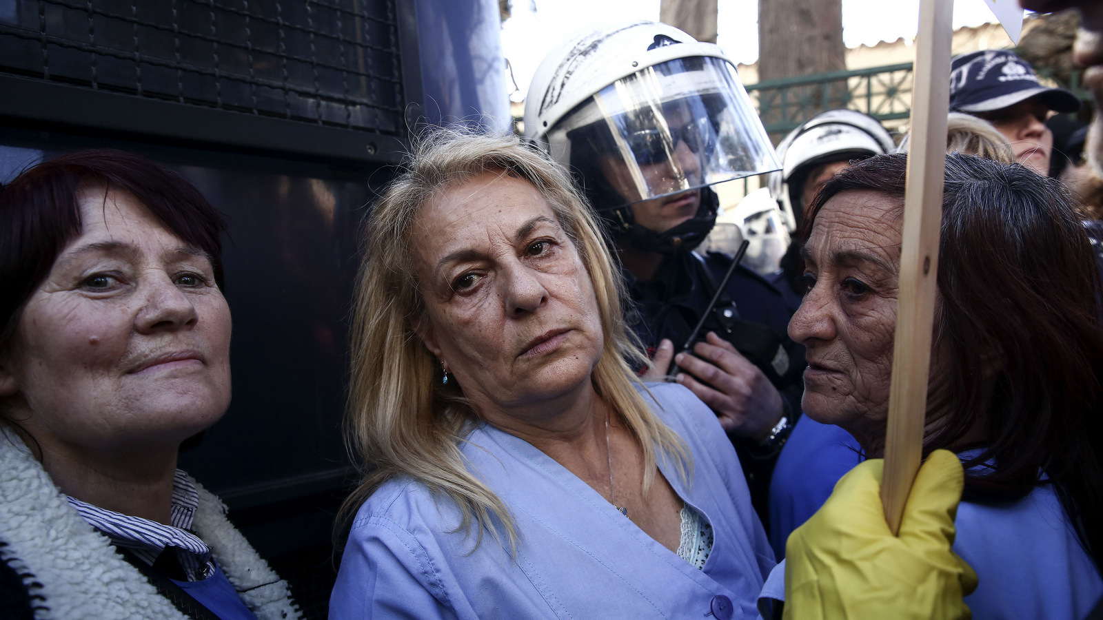 State hospital cleaning workers stand in front of policemen, blocking the street to the Greek Prime Minister's office, during an anti-austerity rally in Athens, Thursday, March 2, 2017. Monitors from Greece's EU creditors and the IMF re-launched talks in Athens on Tuesday on the country's stumbling bailout program. (AP/Yorgos Karahalis)