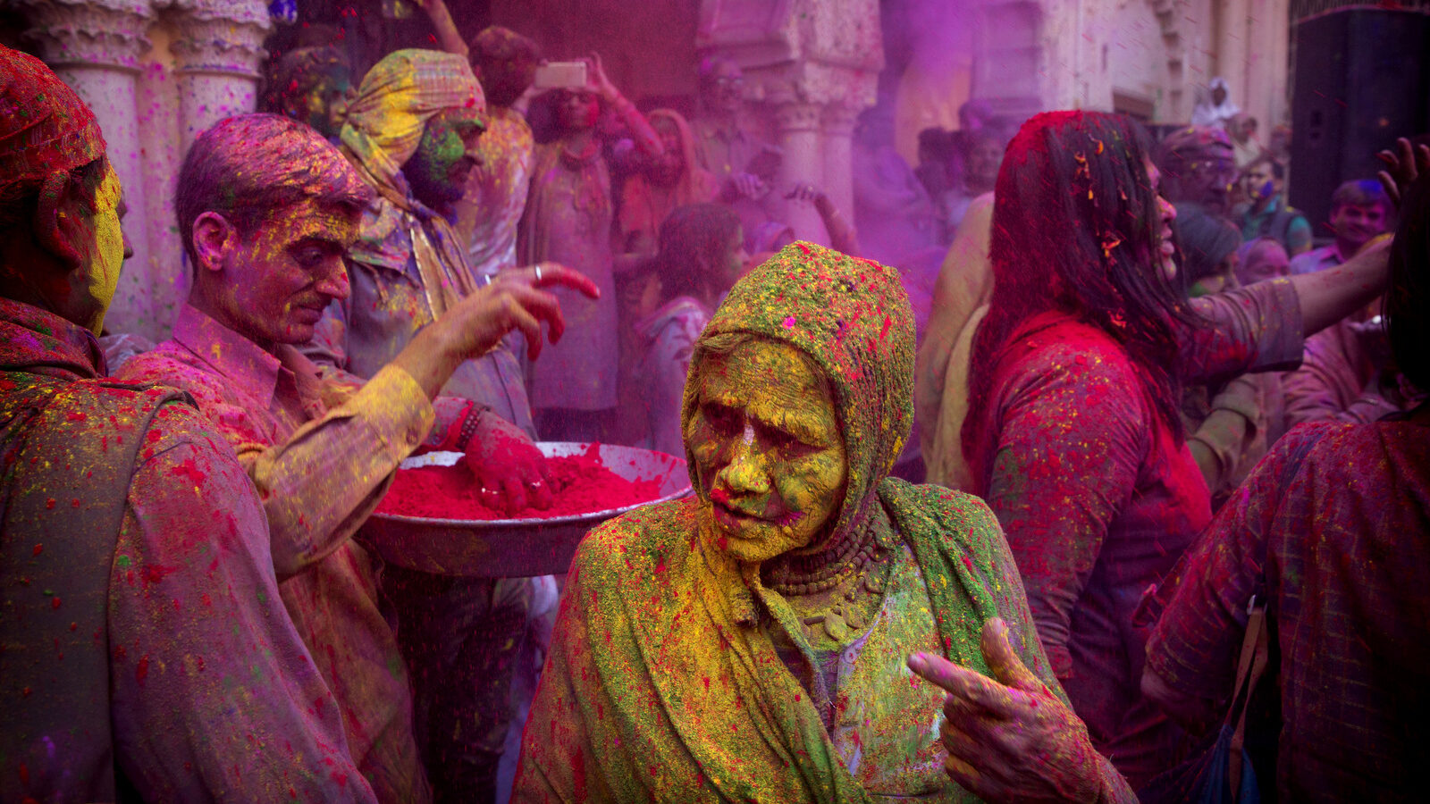 An Indian widow smeared with colors play Holi at the Gopinath temple, in Vrindavan, 180 kilometers (112 miles) south-east of New Delhi, India, Thursday, March 9, 2017. Up to just a few years ago the festival was forbidden for Hindu widows. Like hundreds of thousands of observant Hindu women, they would have been expected to live out their days in quiet worship, dressed only in white, with their very presence being considered inauspicious for all religious festivities. (AP/Manish Swarup)