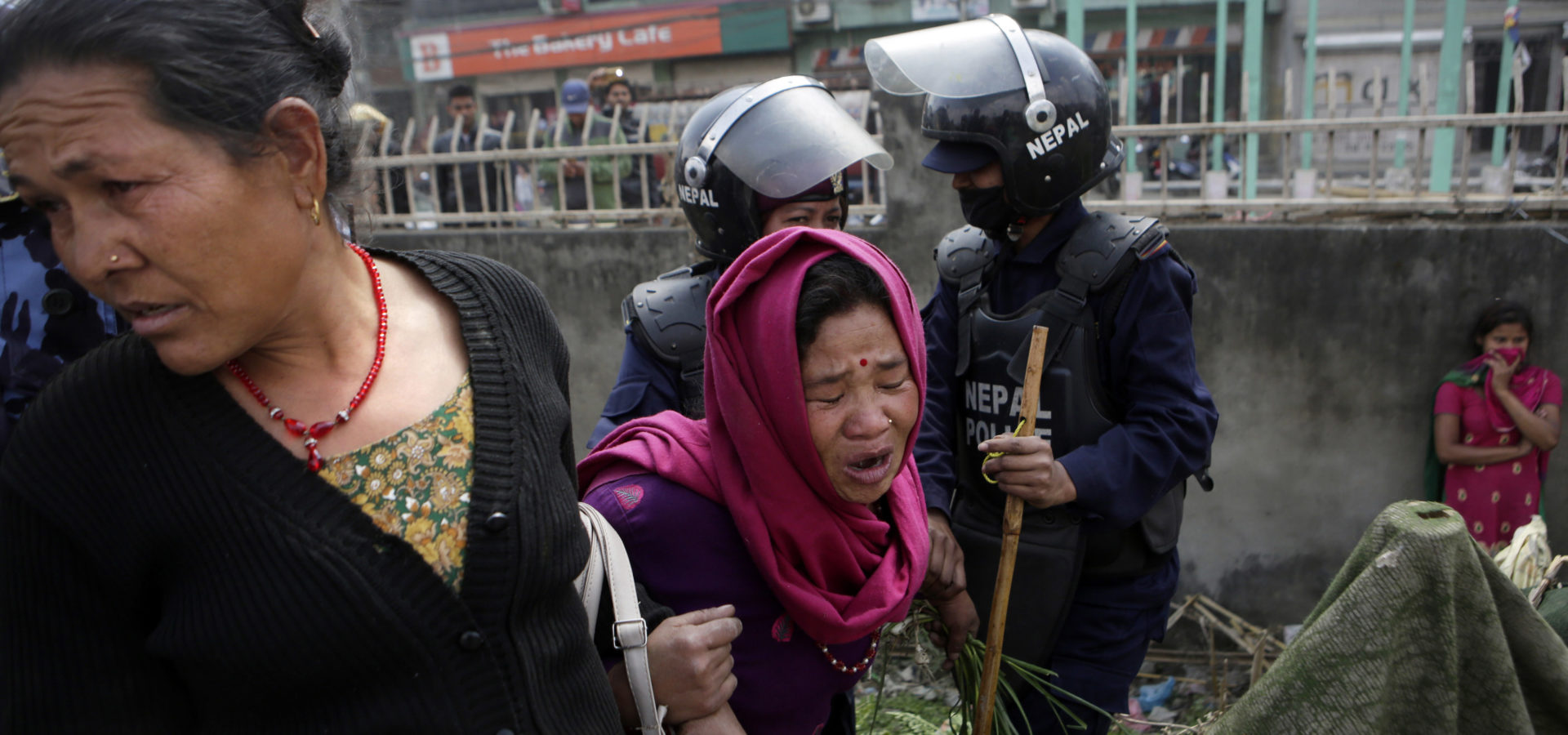 A woman cries as her temporary home was torn down by police in a quake victims' shelter in downtown Kathmandu, Nepal, Tuesday, March 14, 2017. Police tore down hundreds of temporary homes in the Nepalese capital where people who lost their homes in the 2015 earthquake have been living for two years. (AP/Niranjan Shrestha)