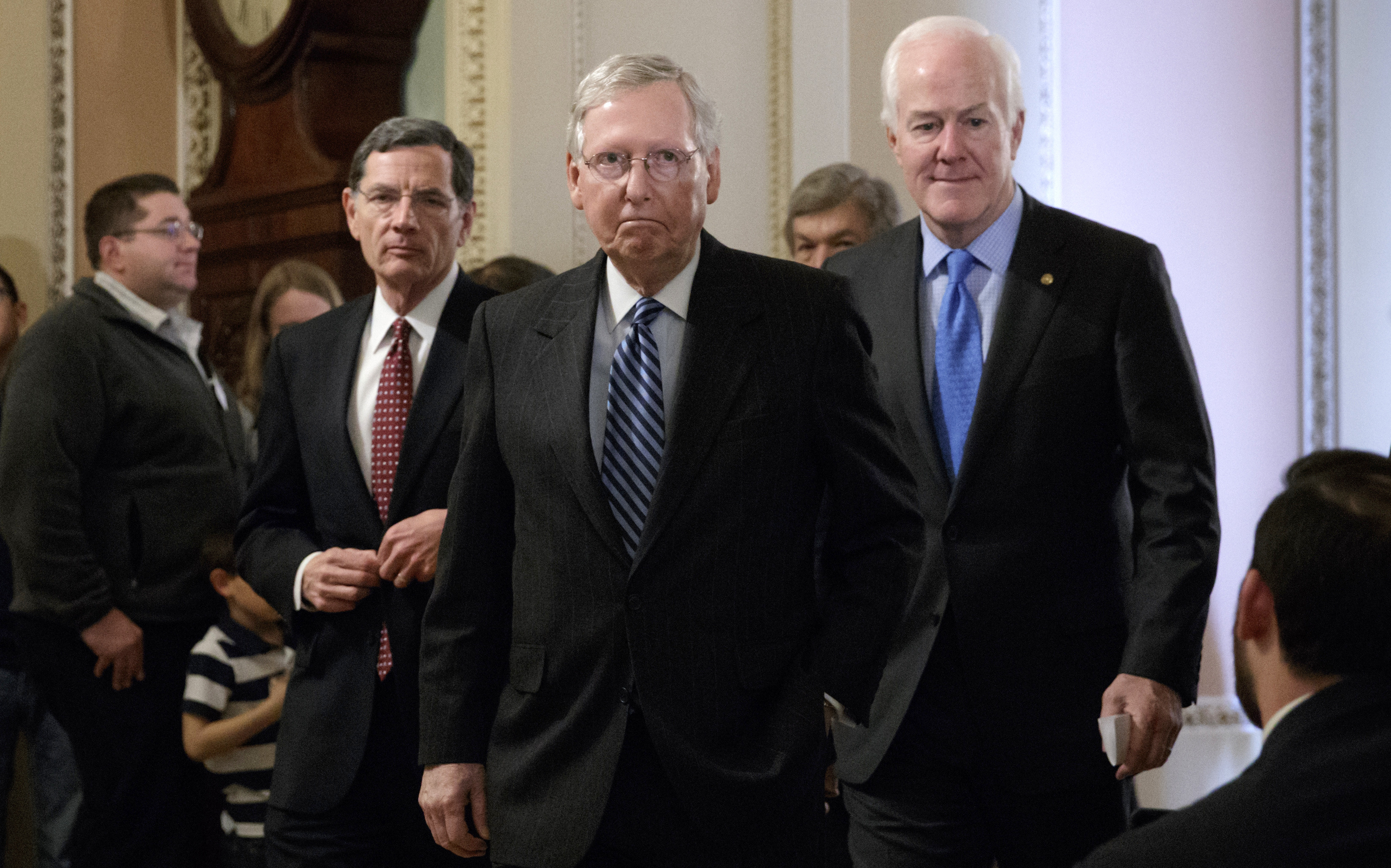 Senate Majority Leader Mitch McConnell, R-Ky., flanked by Sen. John Barrasso, R-Wyo., left, and Majority Whip John Cornyn, R-Texas, arrives to speak with reporters at the Capitol in Washington, Tuesday, March, 14, 2017. The White House and Republican leaders in Congress are scrambling to shore up support for their health care bill after findings from the Congressional Budget Office estimated that 14 million people would lose insurance coverage in the first year alone under the GOP replacement for Obamacare. (AP/J. Scott Applewhite)