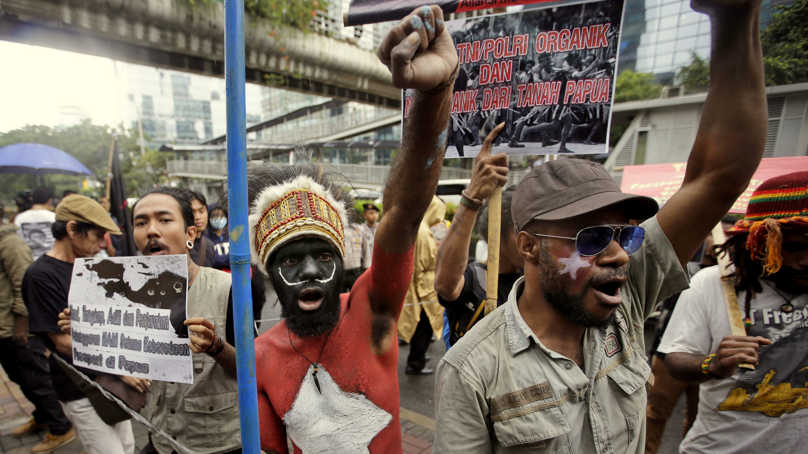 A Papuan activist whose body is painted with the colors of "Morning Star" separatist flag shouts slogans during a protest against the U.S. mining giant Freeport-McMoRan Copper & Gold Inc. in Jakarta, Indonesia, Monday, March 20, 2017. A group of activists staged the protest demanding the New Orleans-based mining company close its mine in Papua province saying that it siphons off the region's wealth and gives it little in return. (AP/Achmad Ibrahim)