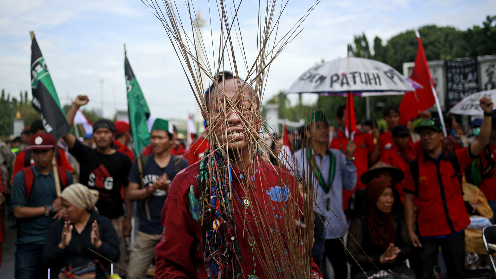 In this March 20, 2017 photo, an activist has skewers wrapped around his head with rubber bands during a rally against the operation of a cement factory in Kendeng, West Java, outside the presidential palace in Jakarta, Indonesia. Kendeng farmers have battled against plans for the factory for years, saying it could taint their water. The factory is now more or less complete and the owner, state-owned PT Semen Indonesia, has said it would create jobs and boost the local economy. (AP/Dita Alangkara)