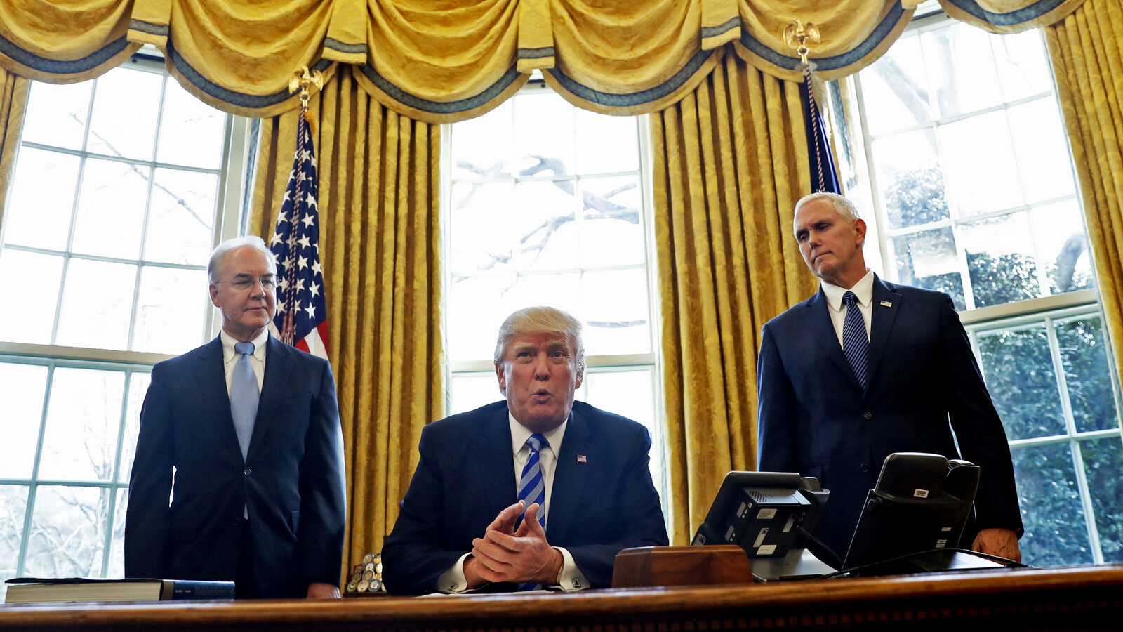 President Donald Trump, flanked by Health and Human Services Secretary Tom Price, left, and Vice President Mike Pence, meets with members of the media regarding the health care overhaul bill, March 24, 2017. (AP/Pablo Martinez Monsivais)