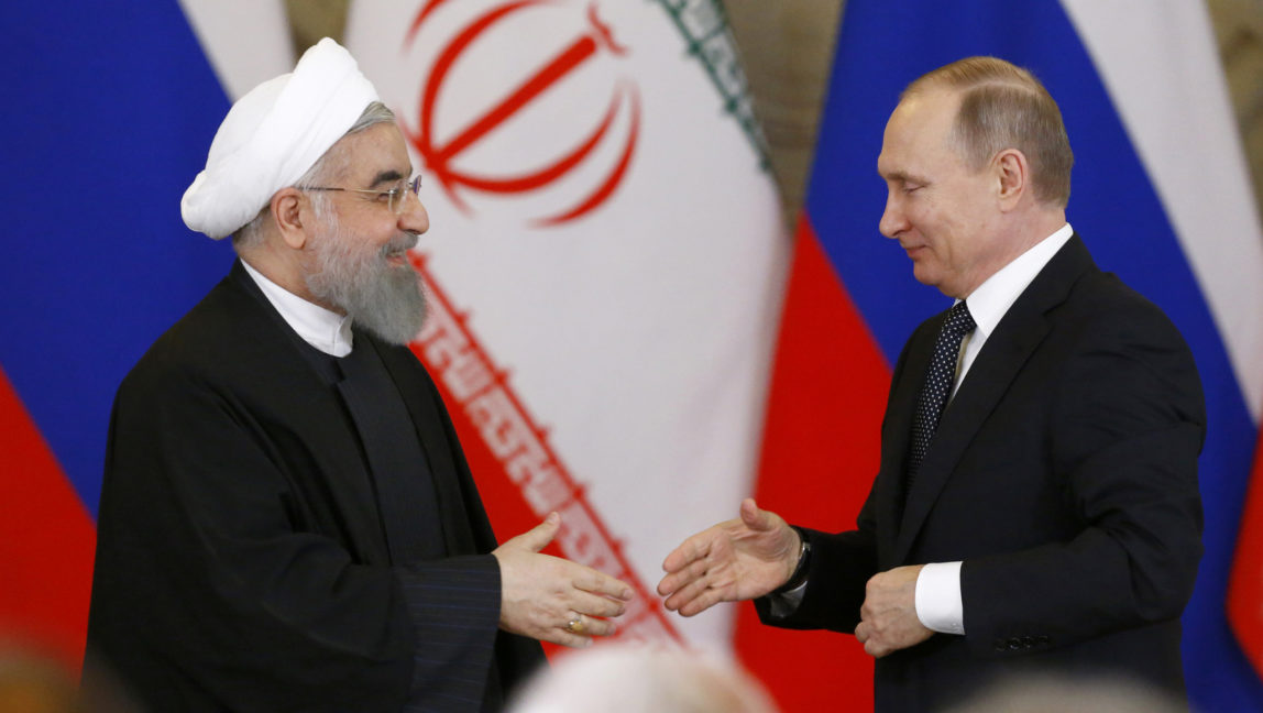Russian President Vladimir Putin, right, shakes hands with Iranian President Hassan Rouhani during a joint news conference at the Kremlin in Moscow, Russia, Tuesday, March 28, 2017. Russia and Iran agreed to boost their energy cooperation and continue joint efforts to help Syrian settlement. (Sergei Karpukhin/AP)