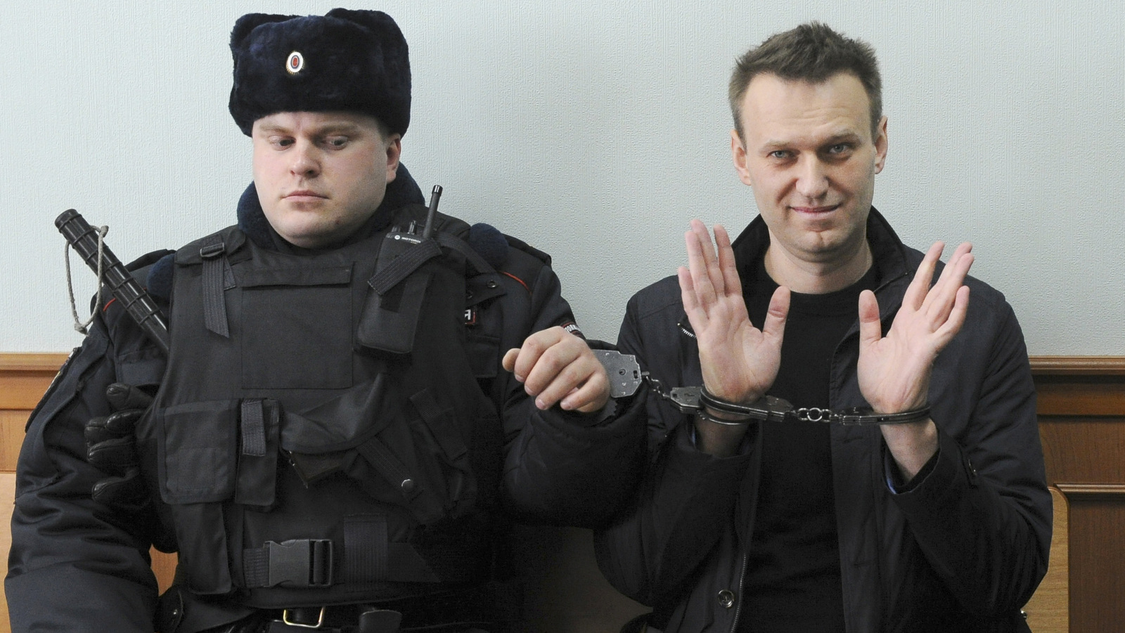 Russian opposition leader Alexei Navalny, right, poses for press in court in Moscow, Russia, Thursday, March 30, 2017. Navalny attends a court hearing on his appeal. Navalny, who organized a wave of nationwide protests against government corruption was sentenced to 15 days in jail. (AP Photo)