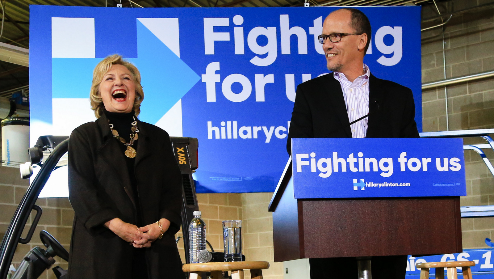 Hillary Clinton laughs as Tom Perez endorses her during a campaign stop in Sioux City, Iowa, Dec. 4, 2015. (AP/Nati Harnik)