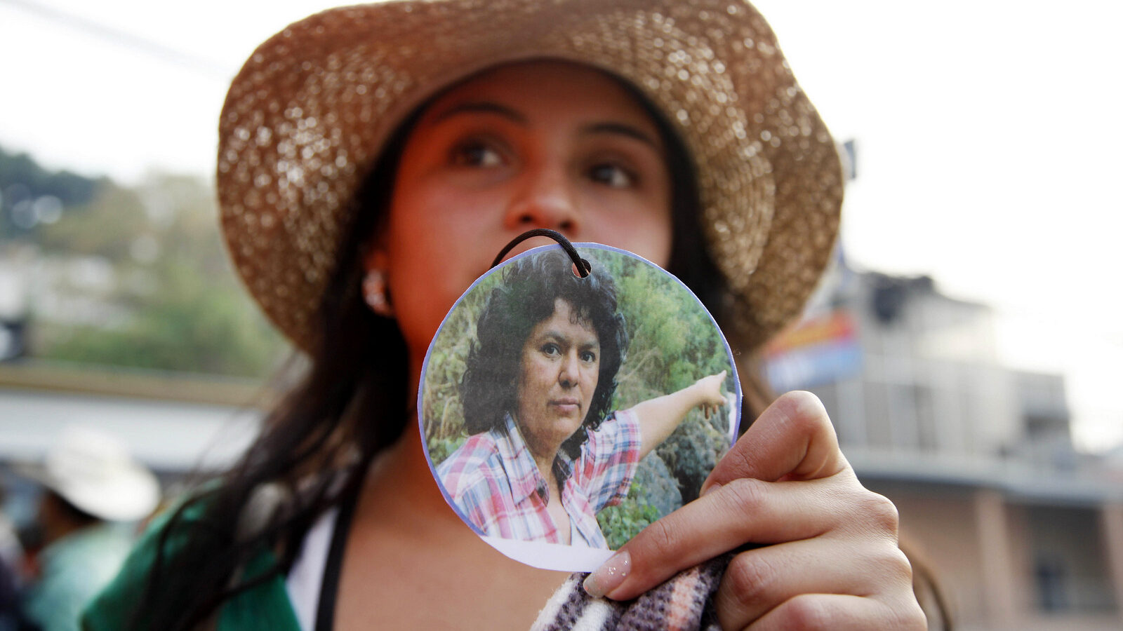 A woman shows a photo of slain environmentalist and indigenous leader and Berta Caceres outside the presidential office in Tegucigalpa, Honduras, Monday, May 9, 2016. (AP/Fernando Antonio)