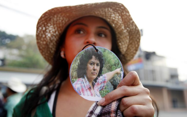 A woman shows a photo of slain environmentalist and indigenous leader and Berta Caceres outside the presidential office in Tegucigalpa, Honduras, Monday, May 9, 2016. (AP/Fernando Antonio)