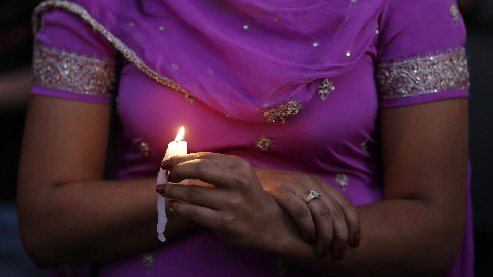 A woman takes part in a candle light vigil for the victims of the Sikh Temple of Wisconsin shooting, Aug. 5, 2012, in Milwaukee. An unidentified gunman killed six people at the suburban Milwaukee temple, confusing them for Muslim worshipers. (AP/Jeffrey Phelps)