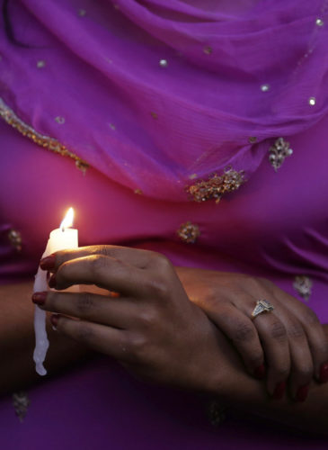 A woman takes part in a candle light vigil for the victims of the Sikh Temple of Wisconsin shooting, Aug. 5, 2012, in Milwaukee. An unidentified gunman killed six people at the suburban Milwaukee temple, confusing them for Muslim worshipers. (AP/Jeffrey Phelps)