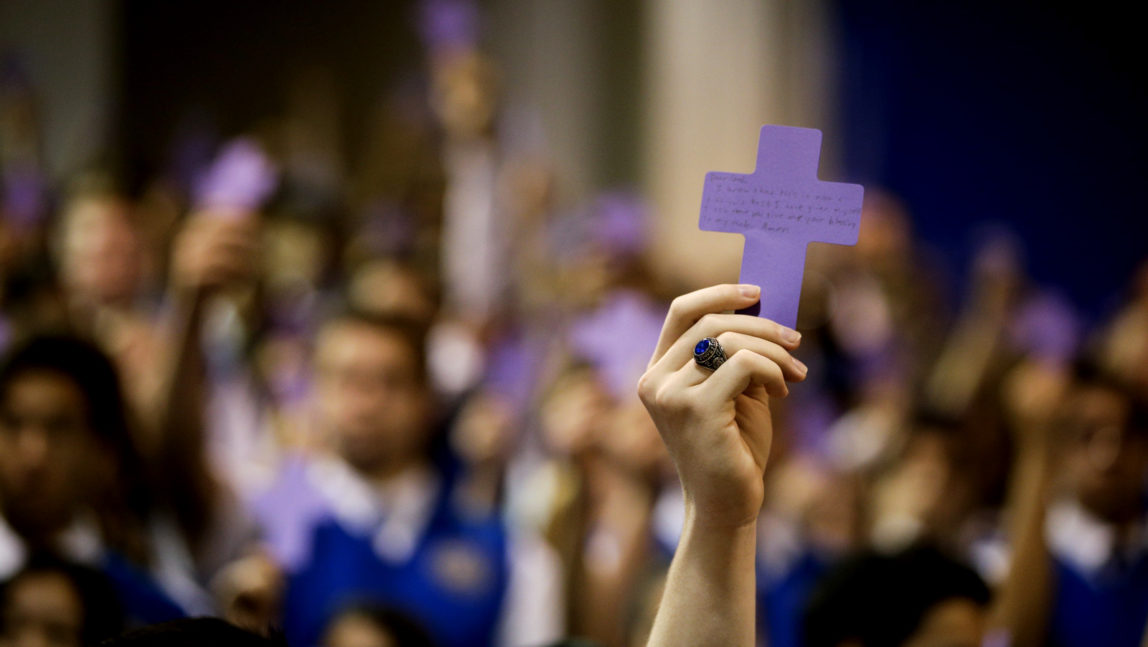 Students hold up paper crosses during at Christian High School in Rancho Santa Margarita, Calif. March 5, 2014. (AP/Jae C. Hong)