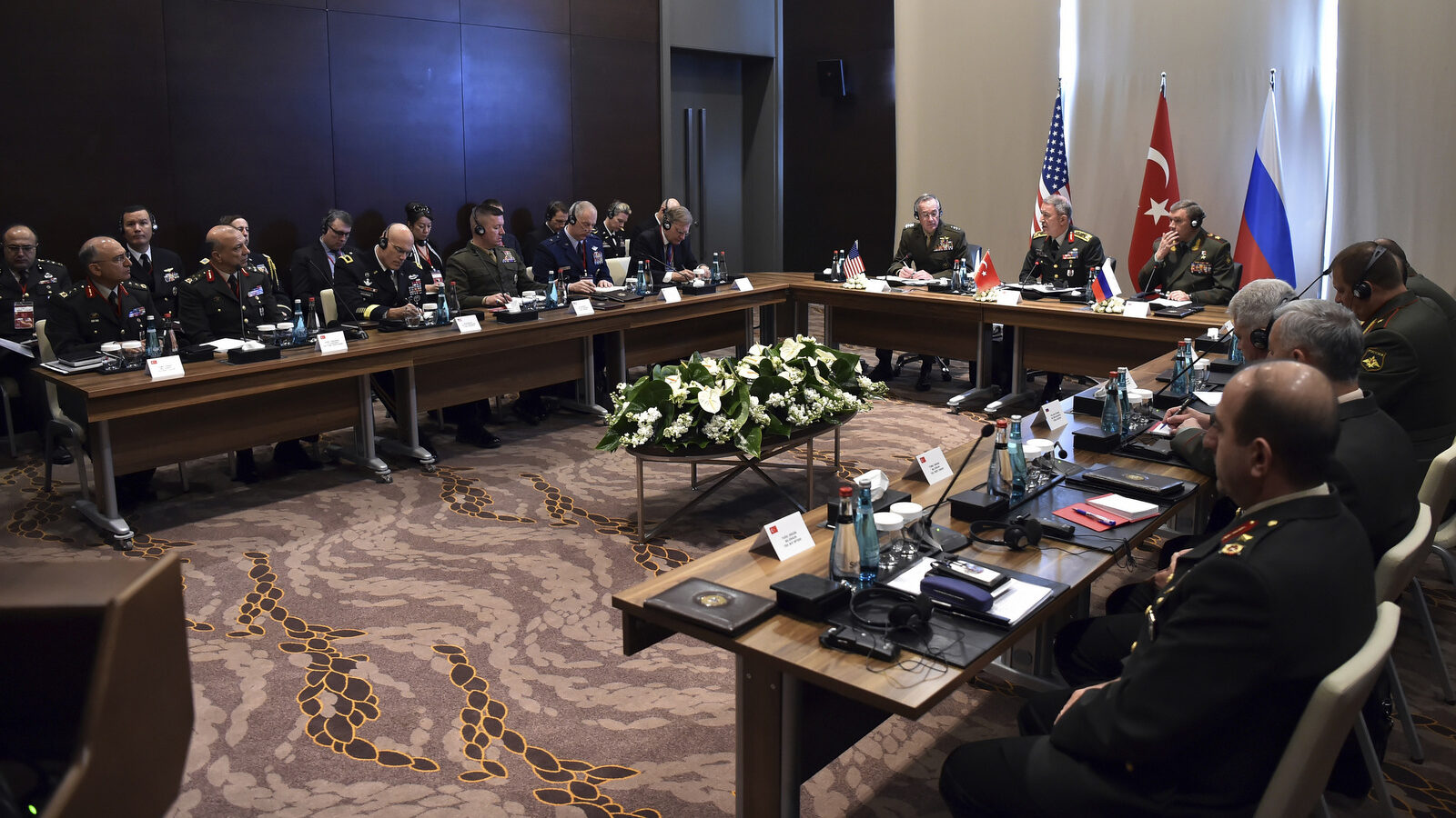 Turkey's Chief of Staff Gen. Hulusi Akar, center, U.S. Chairman of the Joint Chiefs of Staff Gen. Joseph Dunford, left, and Russia's Chief of Staff Gen. Valery Gerasimov and their delegations attend a meeting in the Mediterranean coastal city of Antalya, Turkey, Tuesday, March 7, 2017. Turkey's military says the Turkish, U.S. and Russian chiefs of military staff are meeting in southern Turkey to discuss developments in Syria and Iraq. The meeting comes amid renewed Turkish threats to hit U.S.-backed Syrian Kurdish targets in the northern Syrian city of Manbij. (Turkish Military, Pool Photo via AP)
