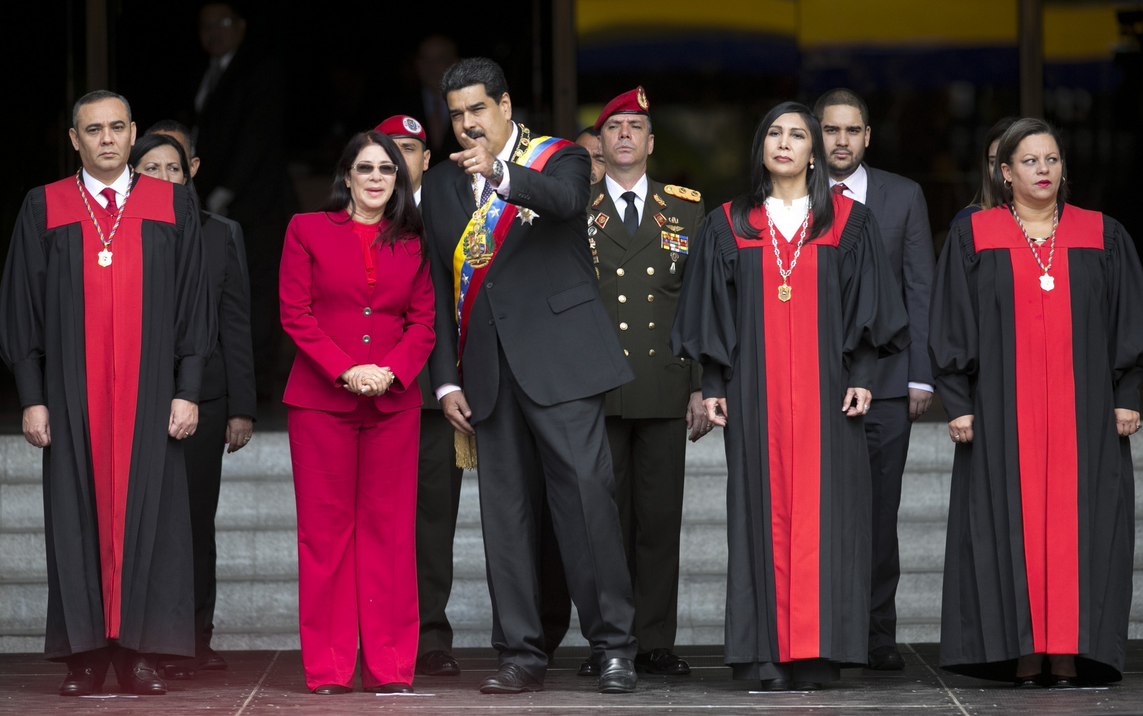 Venezuela's President Nicolas Maduro speaks with first lady Cilia Flores as they arrive to the Supreme Court, before delivering his state of the union address, in Caracas, Venezuela. (AP/Ariana Cubillos)