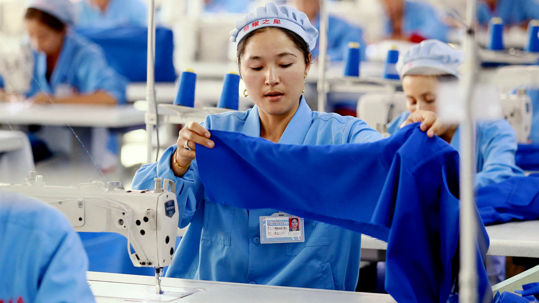 Chinese workers sew clothes at a garment factory in Wuqia town, Kuqa county, Aksu Prefecture, northwest China's Xinjiang Uygur Autonomous Region, 27 September 2016. (Photo: Imaginechina/AP)