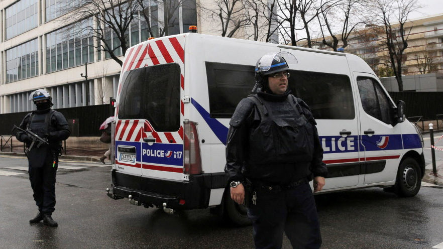 Police officers guard the General Directorate for Internal Security headquarters in Levallois Perret, outside Paris, 2015. (Photo: Christophe Ena/AP)