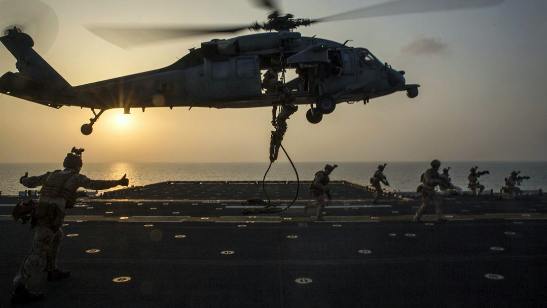 Marines fast-rope out of an SH-60 Seahawk during an exercise on the USS Bataan at sea, March 29, 2017. (Marine Corps/Brianna Gaudi)
