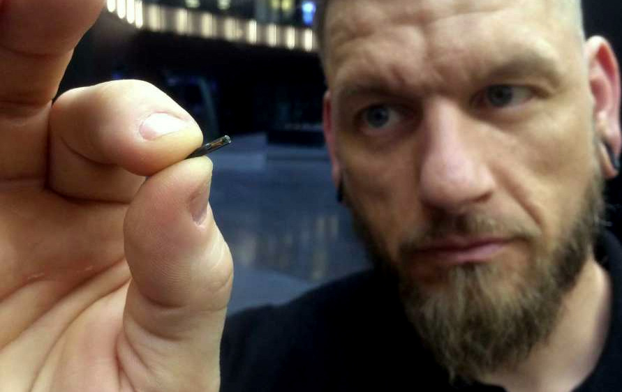 Self-described “body hacker” Jowan Osterlund from Biohax Sweden, holds a small microchip implant, similar to those implanted into workers at the Epicenter digital innovation business centre during a party at the co-working space in central Stockholm, Tuesday March 14, 2017. (Photo: James Brooks/AP)