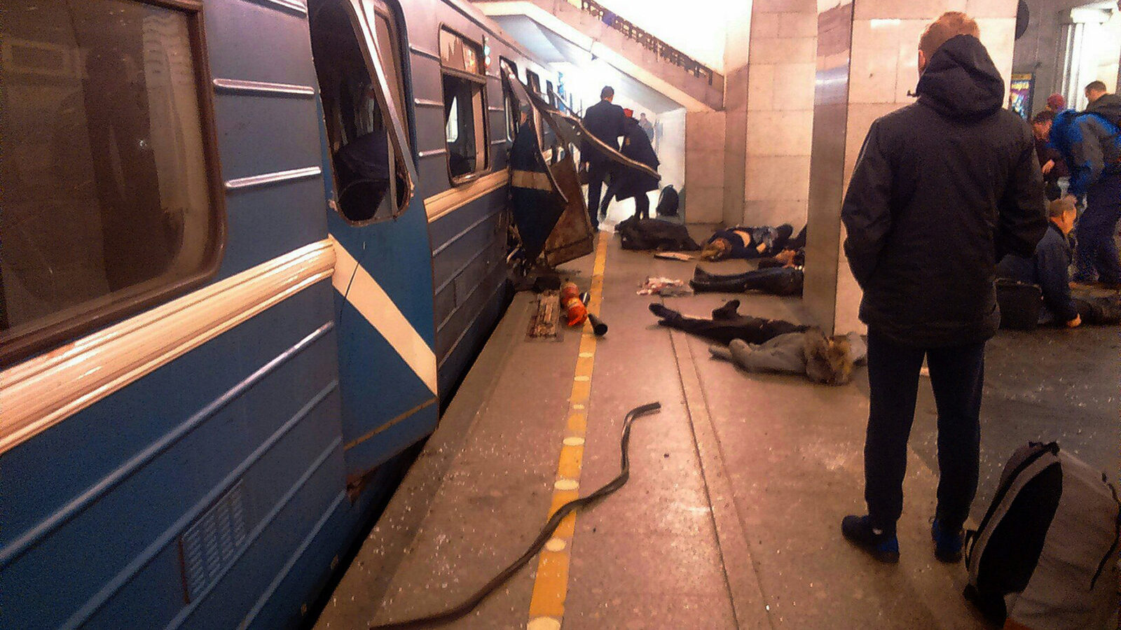 Blast victims lie near a subway train hit by a explosion at the Tekhnologichesky Institut subway station in St.Petersburg, Russia, Monday, April 3, 2017. The subway in the Russian city of St. Petersburg is reporting that several people have been injured in an explosion on a subway train. (AP Photo)