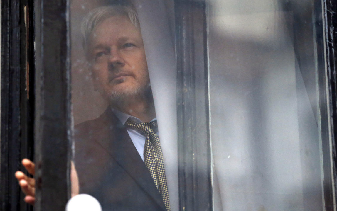 WikiLeaks founder Julian Assange walks onto the balcony of the Ecuadorean Embassy to addresses waiting supporters and media in London, Friday, Feb. 5, 2016. (AP/Frank Augstein)