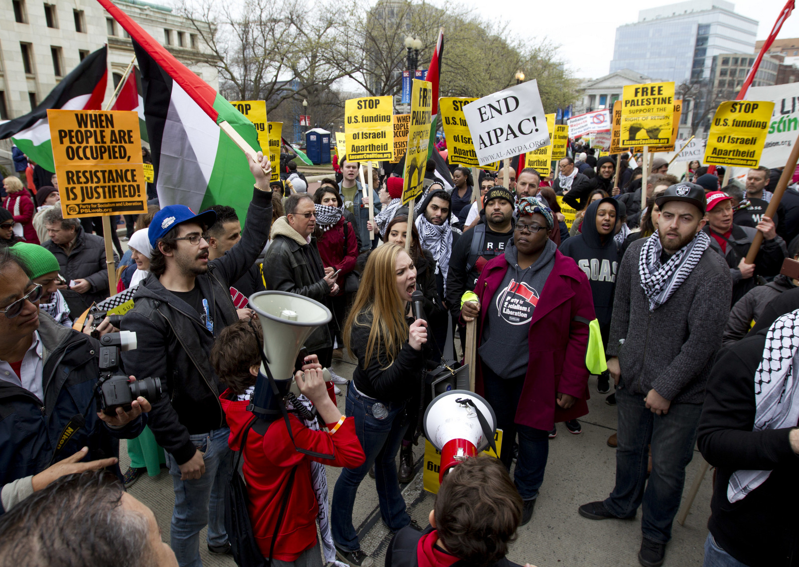 People protest outside of the Washington Convention Center where the 2017 AIPAC Policy Conference is taking place in Washington, Sunday, March 26, 2017. (AP Photo/Jose Luis Magana)