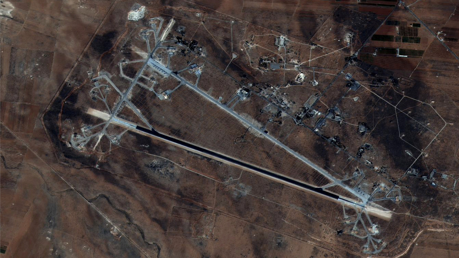 This Oct. 7, 2016 satellite image released by the U.S. Department of Defense shows Shayrat air base in Syria after it was blasted with a barrage of cruise missiles on Friday, April 7, 2017. (DigitalGlobe/U.S. DOD)