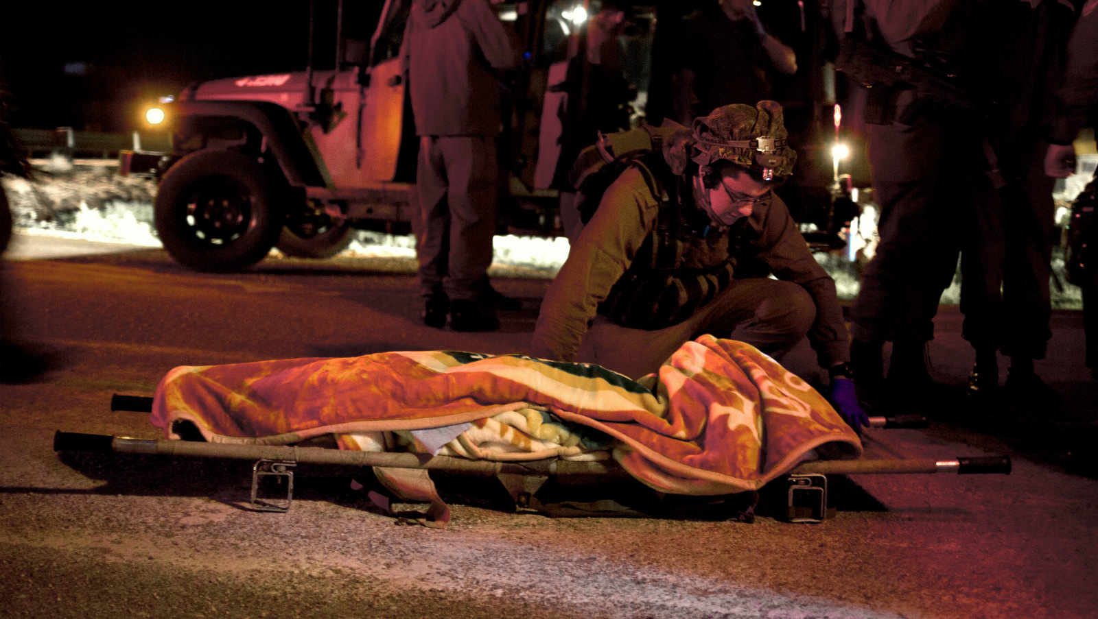 An Israeli military medic talks to a badly wounded Syrian. (AP/Dusan Vranic)