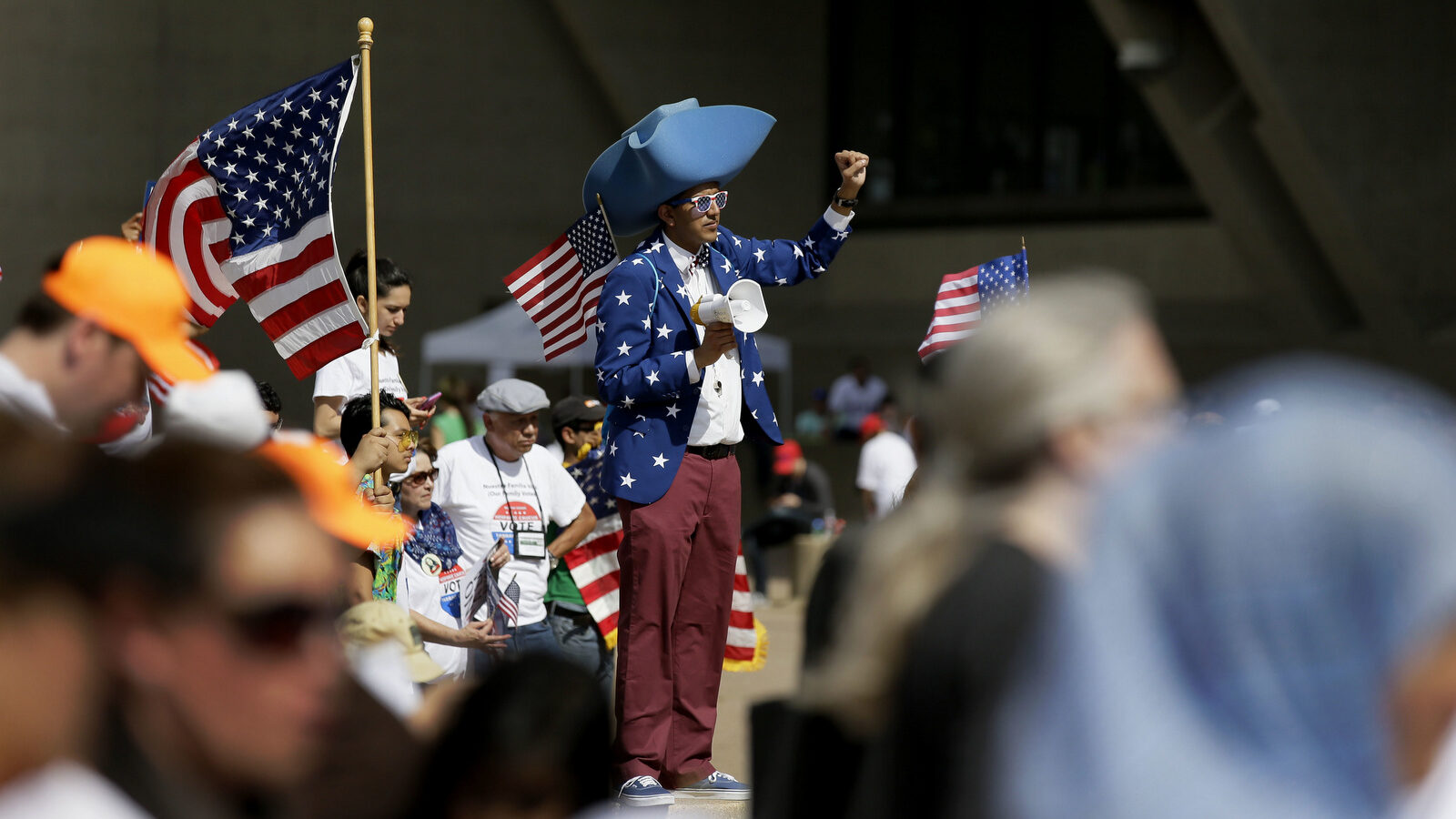 Bhavik Patel raises his fist during a protest rally in downtown Dallas, Sunday, April 9, 2017. Thousands of people are marching and rallying in downtown Dallas to call for an overhaul of the nation's immigration system and end to what organizers say is an aggressive deportation policy. (AP/LM Otero)
