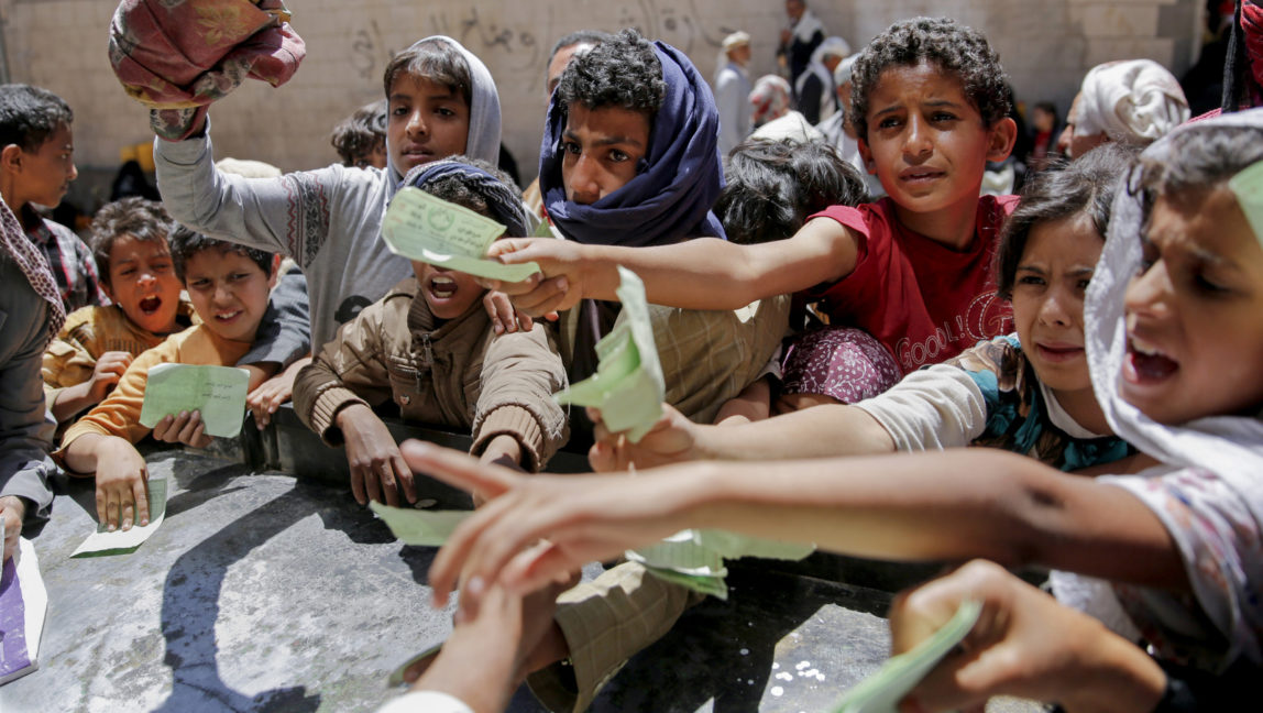 Yemenis present documents in order to receive food rations provided by a local charity, in Sanaa, Yemen, Thursday, April, 13, 2017. A Saudi-led coalition launched a campaign in support of Yemen's internationally recognized government in March 2015. The war has pushed the Arab world's poorest country to the brink of famine. (AP/Hani Mohammed)