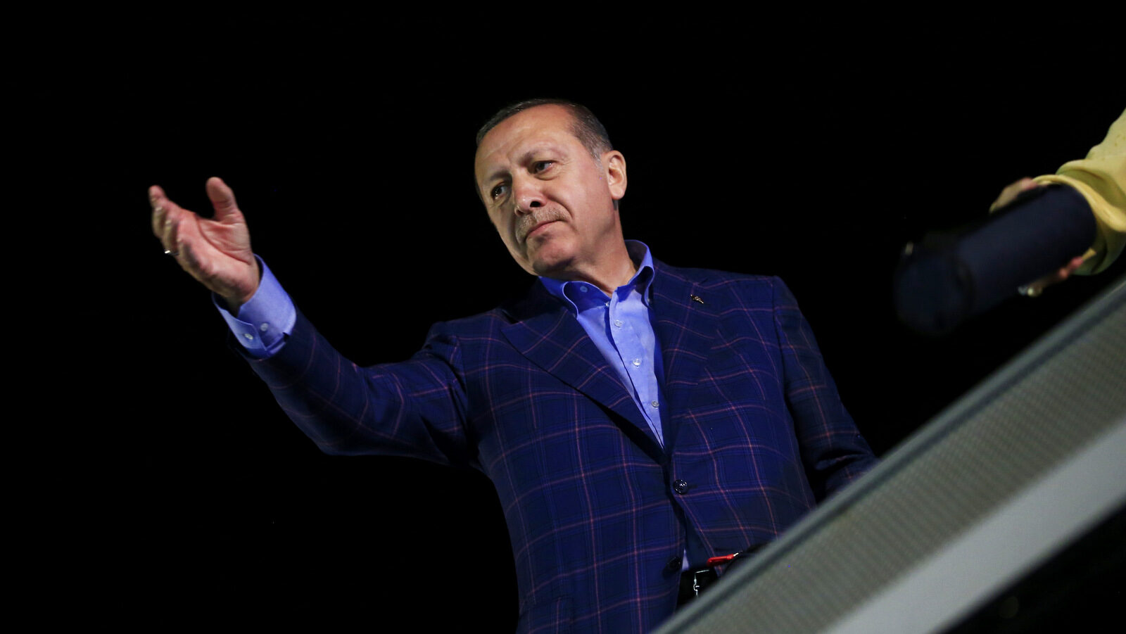 Turkey's President Recep Tayyip Erdogan, waves to supporters in Istanbul, on Sunday, April 16, 2017. Erdogan declared victory in Sunday's historic referendum that will grant sweeping powers to the presidency, hailing the result as a "historic decision." (AP/Lefteris Pitarakis)