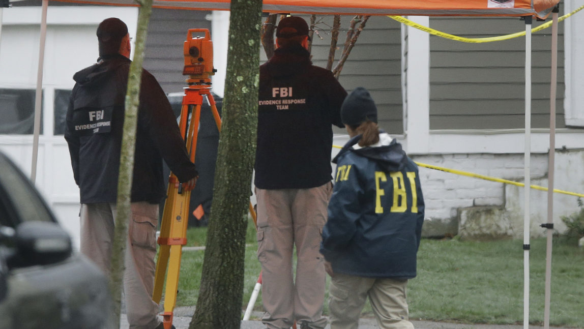 FBI agents investigate the scene in Watertown, Mass., April 23, 2013 where Boston Marathon bombing suspect Dzhokhar Tsarnaev was captured. (AP/Elise Amendola)
