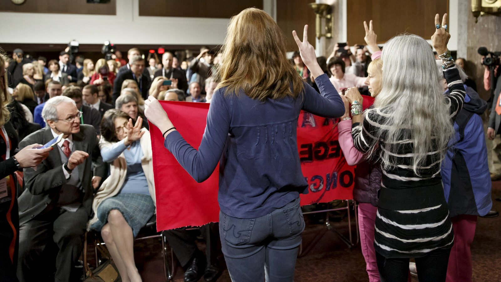 Demonstrators with the activist group Codepink disrupt an event hosted by an organization fighting discrimination against Jews just before a panel discussion with Holocaust survivor Elie Weisel and Sen. Ted Cruz, R-Texas, on Capitol Hill in Washington, Monday, March 2, 2015. (AP/J. Scott Applewhite)