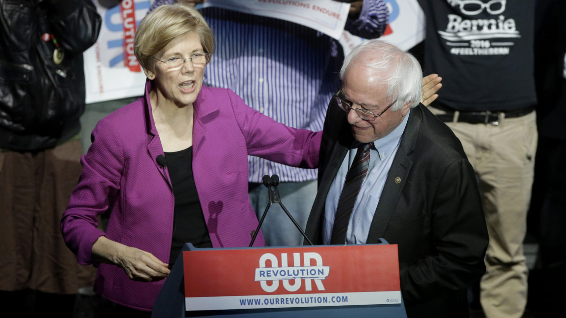 Elizabeth Warren, D-Mass. and Bernie Sanders, I-Vt., greet one another during a rally Friday, March 31, 2017, in Boston. (AP/Steven Senne)