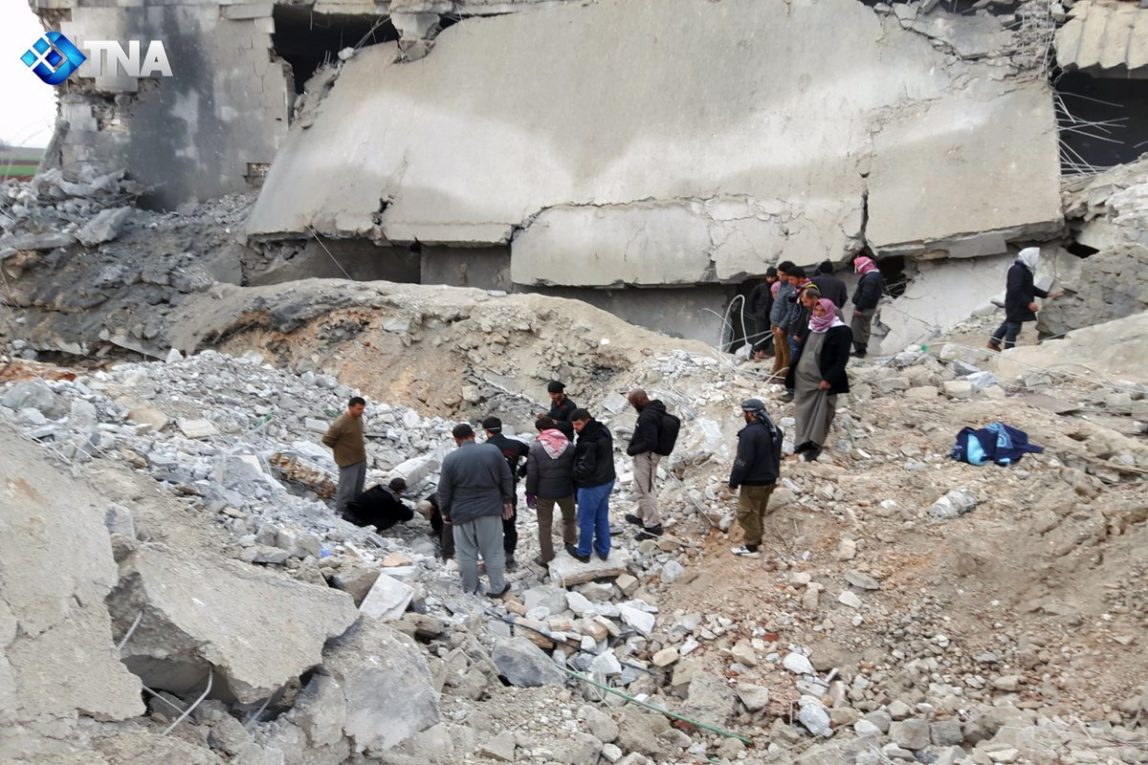 Volunteers dig through the rubble of a mosque following a reported airstrike on a mosque in the village of Al-Jineh in Aleppo province late on March 16, 2017.