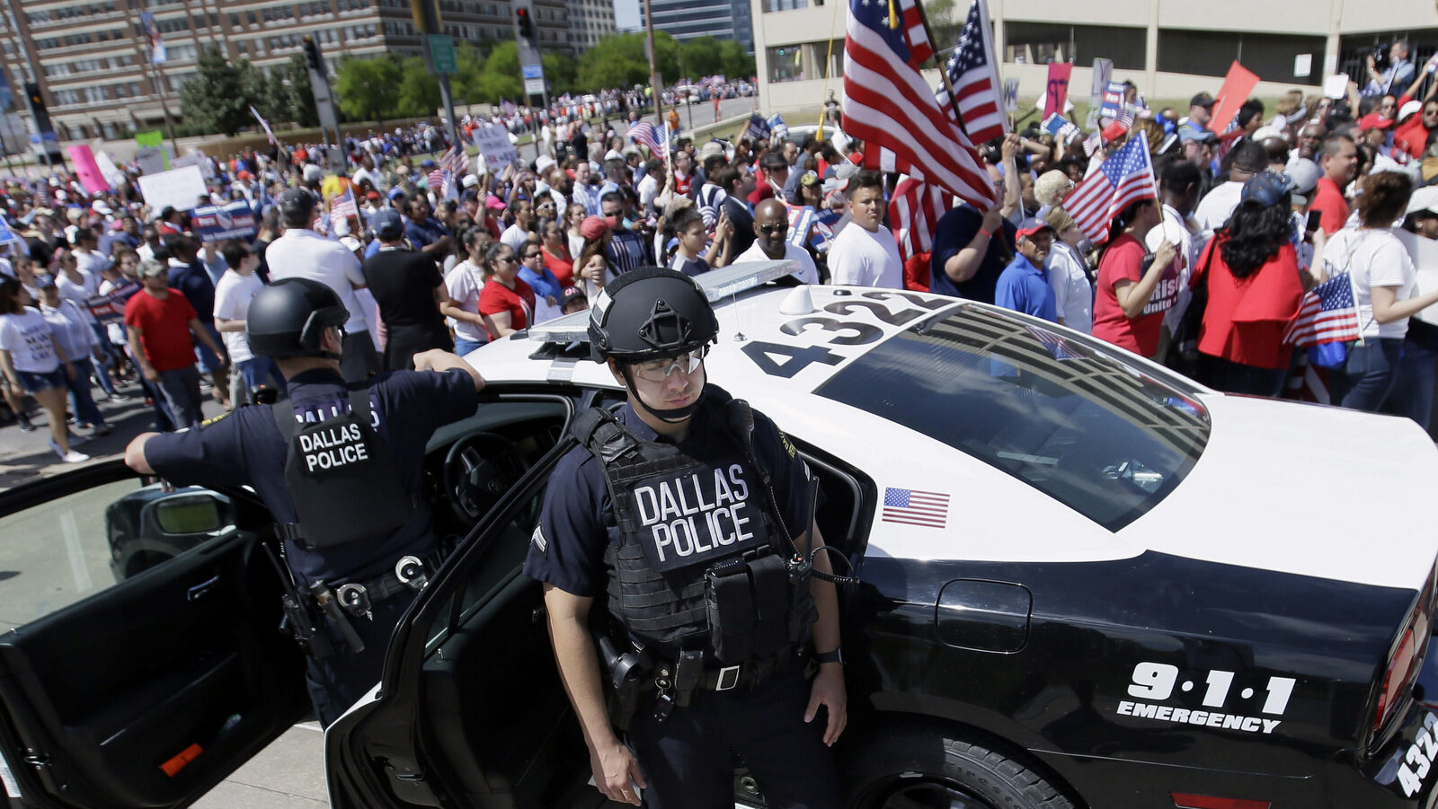 Dallas police stand guard during a protest march through downtown Dallas, Sunday, April 9, 2017. (AP/LM Otero)