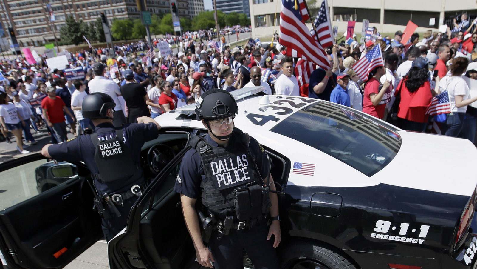 Dallas police stand guard during a protest march through downtown Dallas, Sunday, April 9, 2017.  (AP/LM Otero)